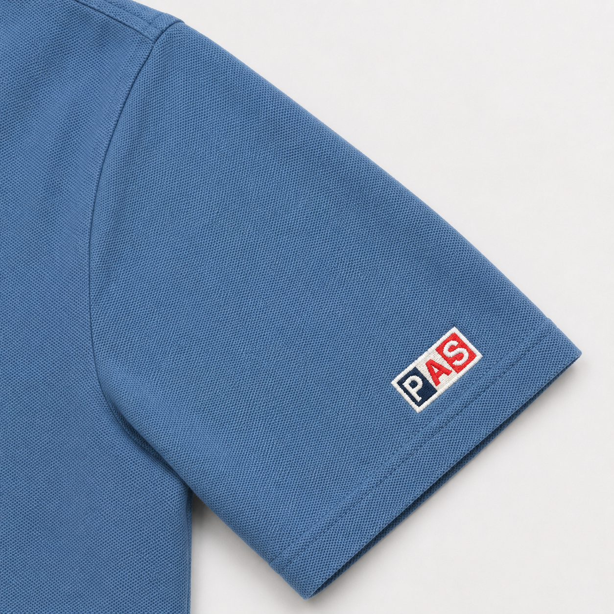 PAS x USA Dos A Cero blue slim fit polo – embroidered PAS x USA arch on front, Dos A Cero stars graphic on back, PAS patch on sleeve