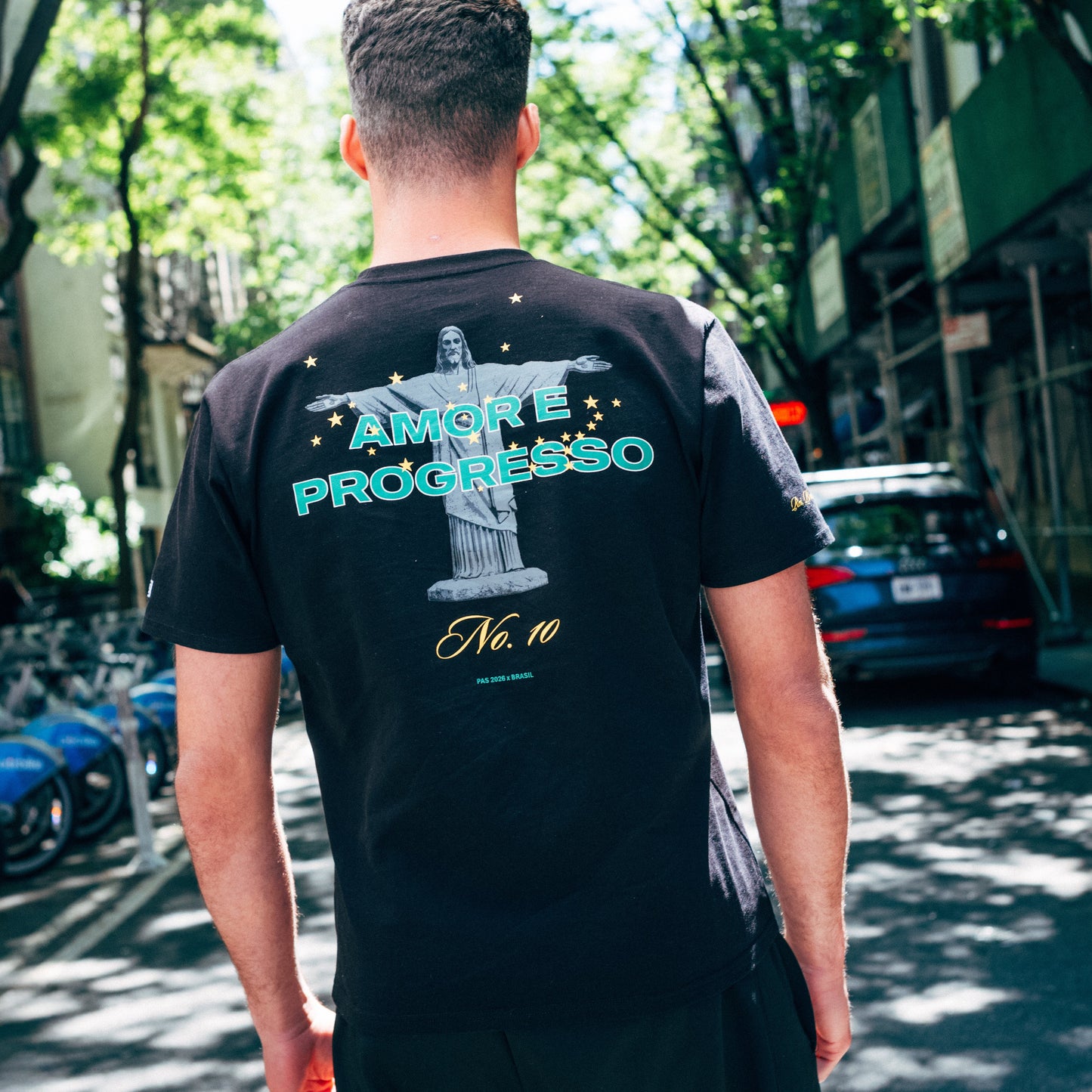 PAS Amor e Progresso Brasil black tee – cross and stars chest graphic, Amor e Progresso No.10 back design, Brazil-colored PAS patch on sleeve