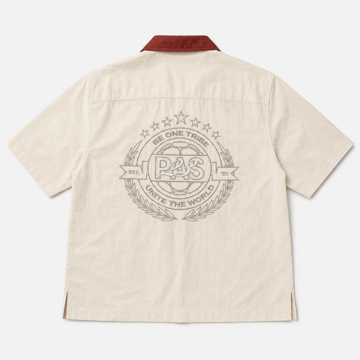 PAS The 23rd One Tribe cream button-up shirt – burgundy contrast collar, PAS 2026 pocket embroidery, Be One Tribe Unite the World crest on back