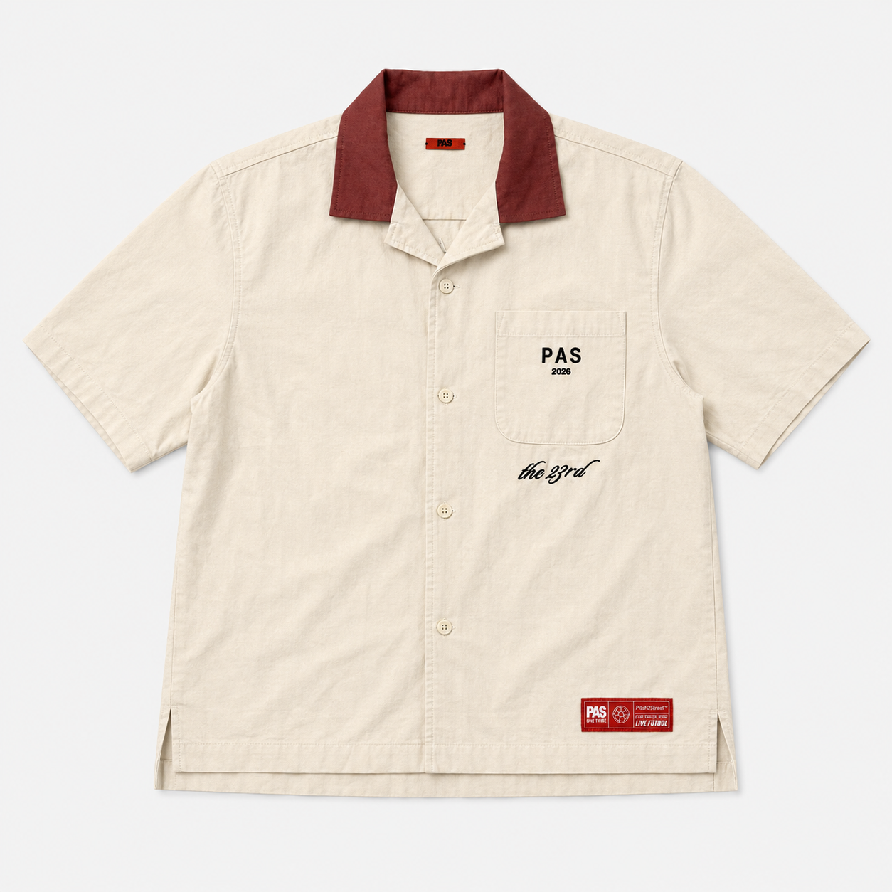 PAS The 23rd One Tribe cream button-up shirt – burgundy contrast collar, PAS 2026 pocket embroidery, Be One Tribe Unite the World crest on back