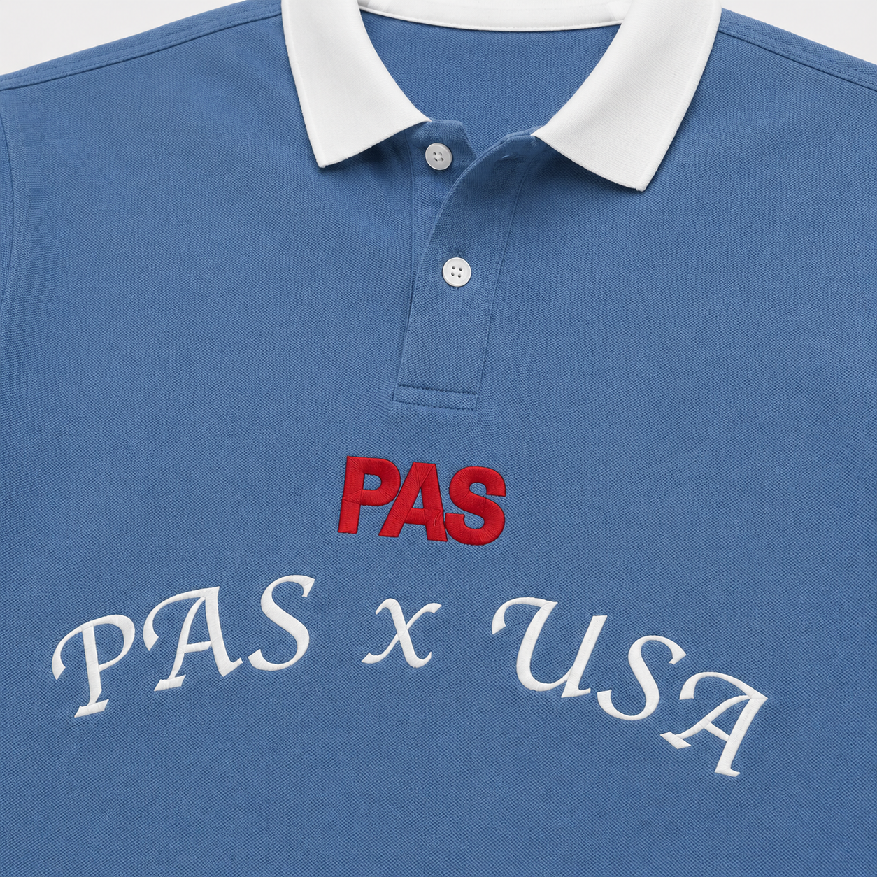 PAS x USA Dos A Cero blue slim fit polo – embroidered PAS x USA arch on front, Dos A Cero stars graphic on back, PAS patch on sleeve